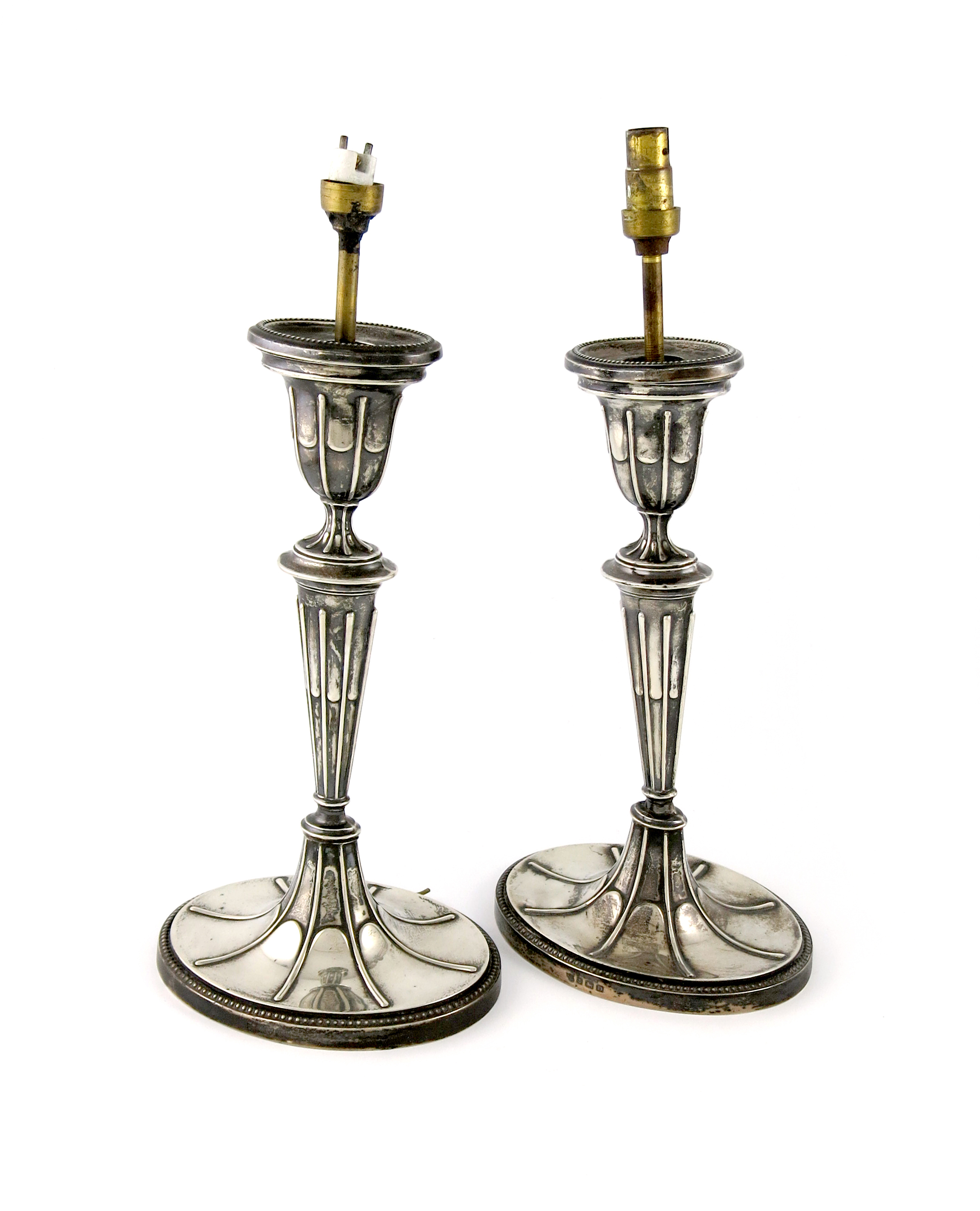 A matched pair of silver candlesticks converted to lamps, by the Barker Brothers, Birmingham 1928,