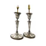 A matched pair of silver candlesticks converted to lamps, by the Barker Brothers, Birmingham 1928,