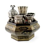 An Indonesian silver and lacquer betel nut set, with a central tapering pot, two boxes and three