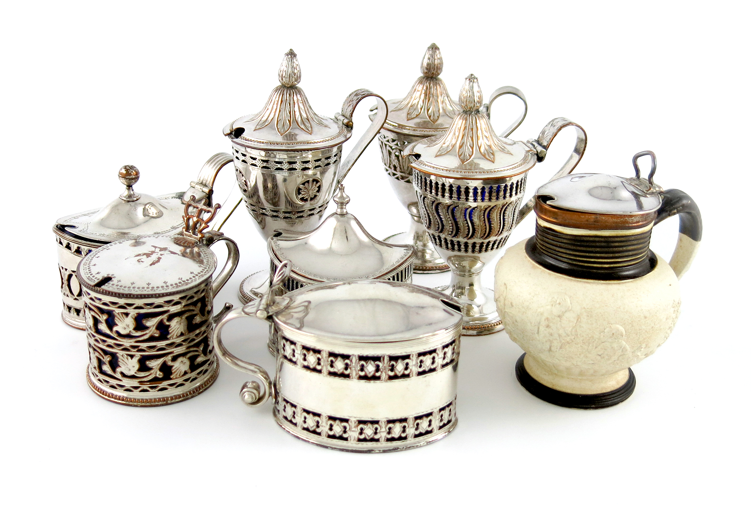 A small collection of seven old Sheffield plated mustard pots, various designs, pierced