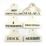A collection of six 19th century ceramic bin labels, some by Copeland, arched rounded rectangular