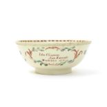 A documentary creamware punchbowl, dated 1776, painted with small polychrome flower sprays,