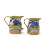 Two large Mochaware jugs, 19th century, decorated with bands of stylized seaweed in blue on a