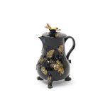 A small Jackfield jug and cover, c.1760-70, applied with tendrils of fruiting vine, the cover