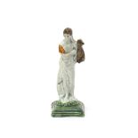 A small Pratt ware figure of Apollo, c.1790, standing and holding a lyre in his left hand, a pile of