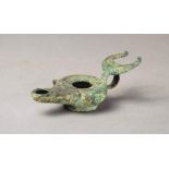 A Roman bronze oil lamp with a ring handle and crescent surmount, 13cm long.