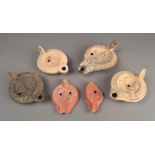 Four pottery lamps Roman and later decorated a lion and figure, a male and female bust, a figure