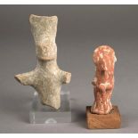 Two Cypriot figures one female in red clay with an arched headdress, pinched nose and a pair of