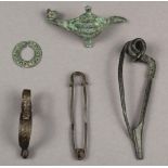 Four bronze fibulae Bronze Age including one finely coiled and ribbed, 6.5cm long, a navicella-type,