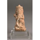A Phoenician terracotta figure of Dagan seated and wearing an elaborated headdress and supporting