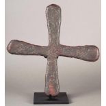 A Katanga currency cross Democratic Republic of Congo copper, 27.5cm wide, on a stand. (2)