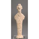 A Syro-Hittitie terracotta figure of Astarte standing with an elaborate coiffure, disc eyes and