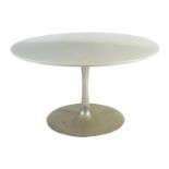 An Arkana Tulip table designed by Eero Saarinen, polished aluminium stem supporting circular