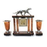 A copper and chromed metal clock garniture, the central clock with four faceted copper columns