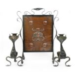 An Arts and Crafts copper mounted fire screen and matched fire-dogs, the patinated metal frame