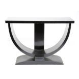 An ebonised wood table, the rectangular top on D shaped support and tapering rectangular foot,
