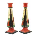 'Red Trees and House' a pair of Clarice Cliff Fantasque Bizarre Elton candlesticks, painted in