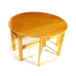 An Andrew Varah exotic wood veneer drop-leaf dining table, designed by Andrew Varah, on eight