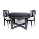 A continental Secessionist limed and ebonised oak extending dining table and six chairs, the round