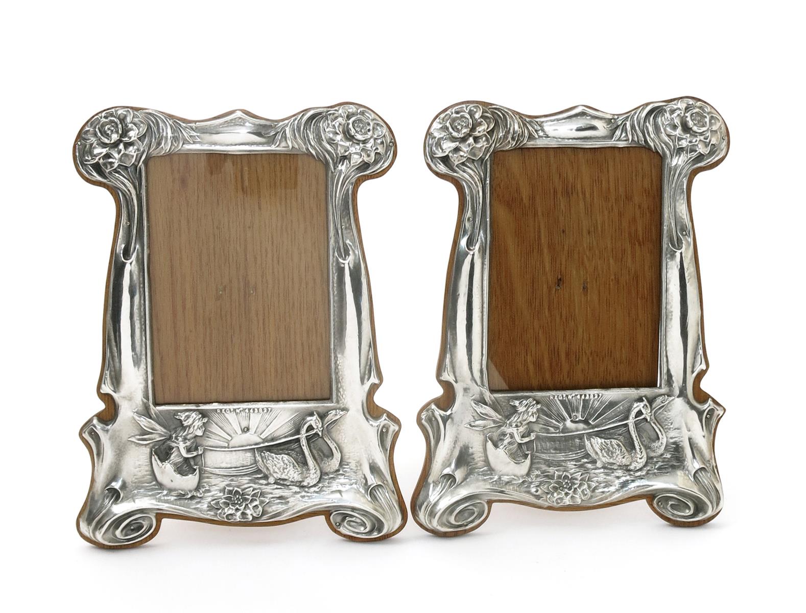 A pair of silver plated on copper photograph frames,