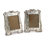 A pair of John Millward Banks silver photograph frames, each stamped in low relief with an Edwardian