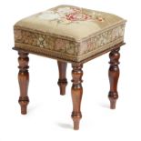 A Victorian mahogany stool, the needlework seat decorated with flowers, on baluster turned legs,