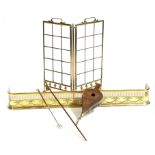 A late Victorian brass and bevelled glass folding fire screen, a brass Adam style fender, a pair