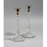 A pair of Victorian glass and brass candlesticks, each with a detachable drip-pan, above a spiral