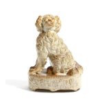 A rare early 19th century saltglaze stoneware pottery model of a spaniel attributed to Brampton,