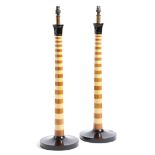 A pair of column table lamps, with ebonised decoration, the shafts with alternating light and dark