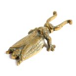 A brass bootjack, in the form of a beetle, 25.8cm long. Provenance: The collection of the late