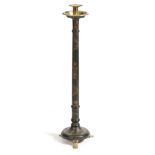 A black lacquer and marquetry inlaid candlestand, with a brass sconce and drip-pan, above a stem and