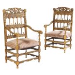 A pair of giltwood open armchairs in Renaissance revival style, the arcaded backs carved with lion's
