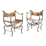 A pair of Italian wrought iron and brass faldistorio type armchairs, each with a leather back and