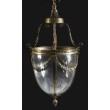 An Adam style brass hall lantern, with leaf capped scroll supports above an ovoid body decorated
