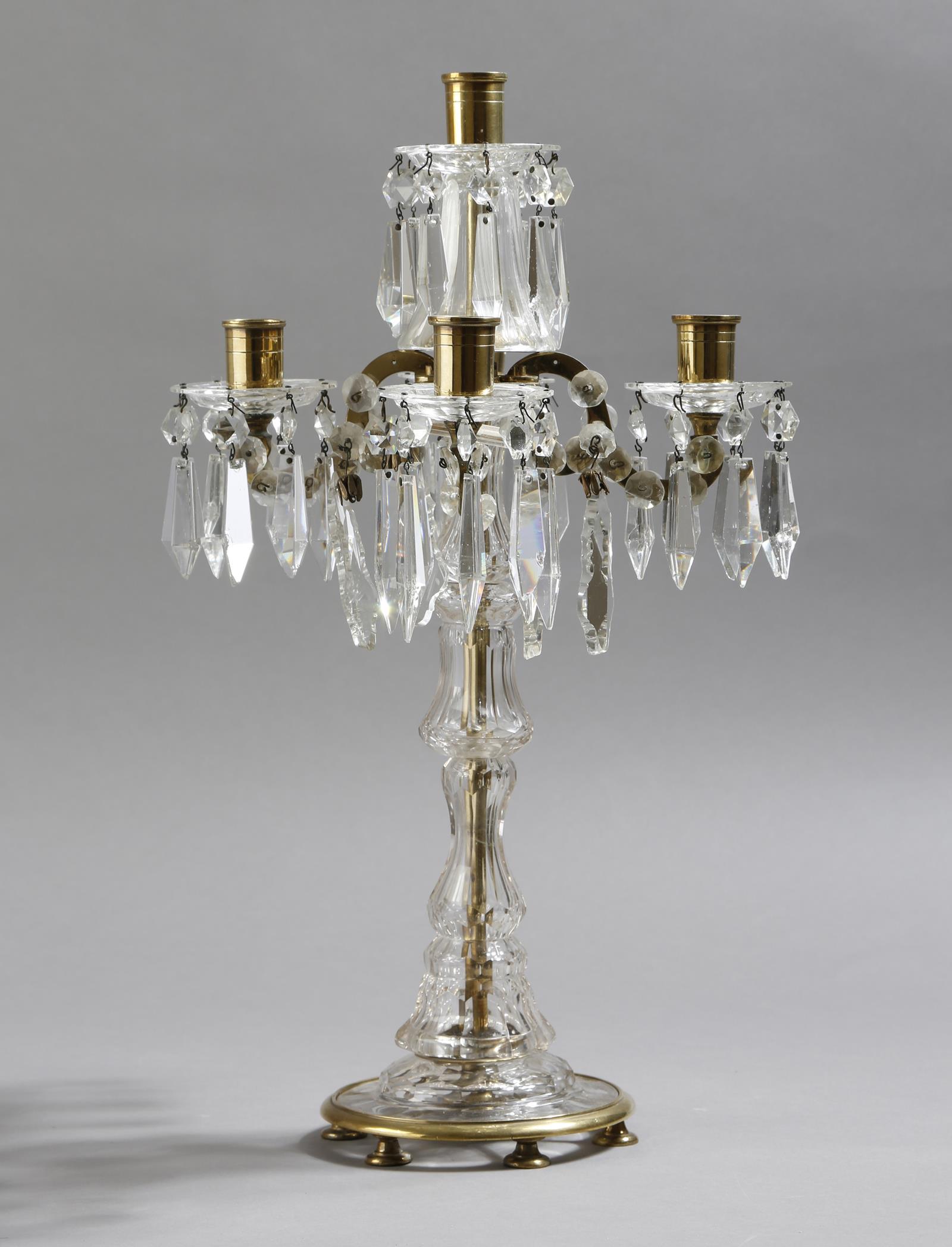 A cut glass and brass five light candelabra by Lobmeyr, with scroll arms with applied discs, the