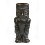 A late 19th century German patinated terracotta owl stickstand, with glass eyes, with indistinct