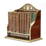 λ A Victorian rosewood and brass bookstand, inlaid with scrolling leaves and flowers, containing: