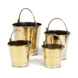 A 19th century graduated set of brass buckets, each with a swing handle, 33.7cm high (max). (4)