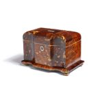 λ A Regency tortoiseshell tea caddy, of sarcophagus shape, inlaid with pewter stringing, the