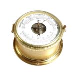 A German brass cased bulkhead style aneroid barometer by Schatz, with thermometer, 18cm diameter.