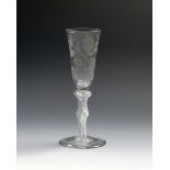 A good cider glass, c.1760, with a tall rounded funnel bowl engraved with a large branch of an apple