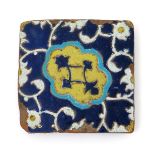 A cuerda seca square tile, 16th century, probably Safavid, decorated with a central panel banded