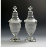 A pair of cut glass sweetmeat jars and covers, early 19th century, the rounded funnel bodies cut