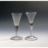 Two large wine glasses, c.1770, with drawn trumpet bowls, one on a plain stem, the other on a