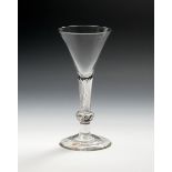A composite stem wine glass, c.1760, the drawn trumpet bowl rising from an airtwist stem above a
