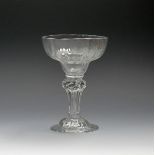 A moulded sweetmeat glass, c.1740, the pan-topped bowl with wide flutes, raised on a pedestal stem