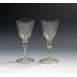 A pair of Dutch-engraved armorial goblets, c.1750-60, with generous rounded funnel bowls raised on