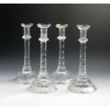 Four large cut glass candlesticks, early 19th century, the slightly tapering faceted forms with