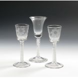 A pair of wine glasses, c.1770, the bucket bowls engraved with a flying insect and stylized